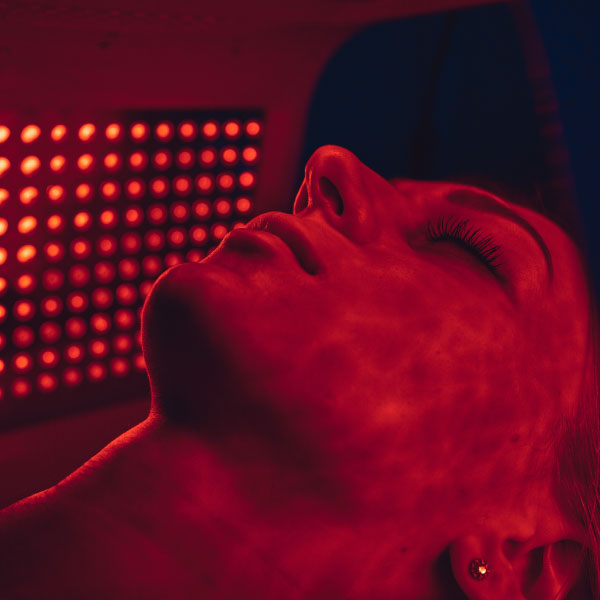 Woman having facial LED treatment