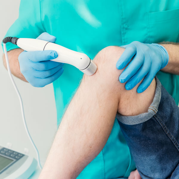 Man treating knee injury with Cryotherapy